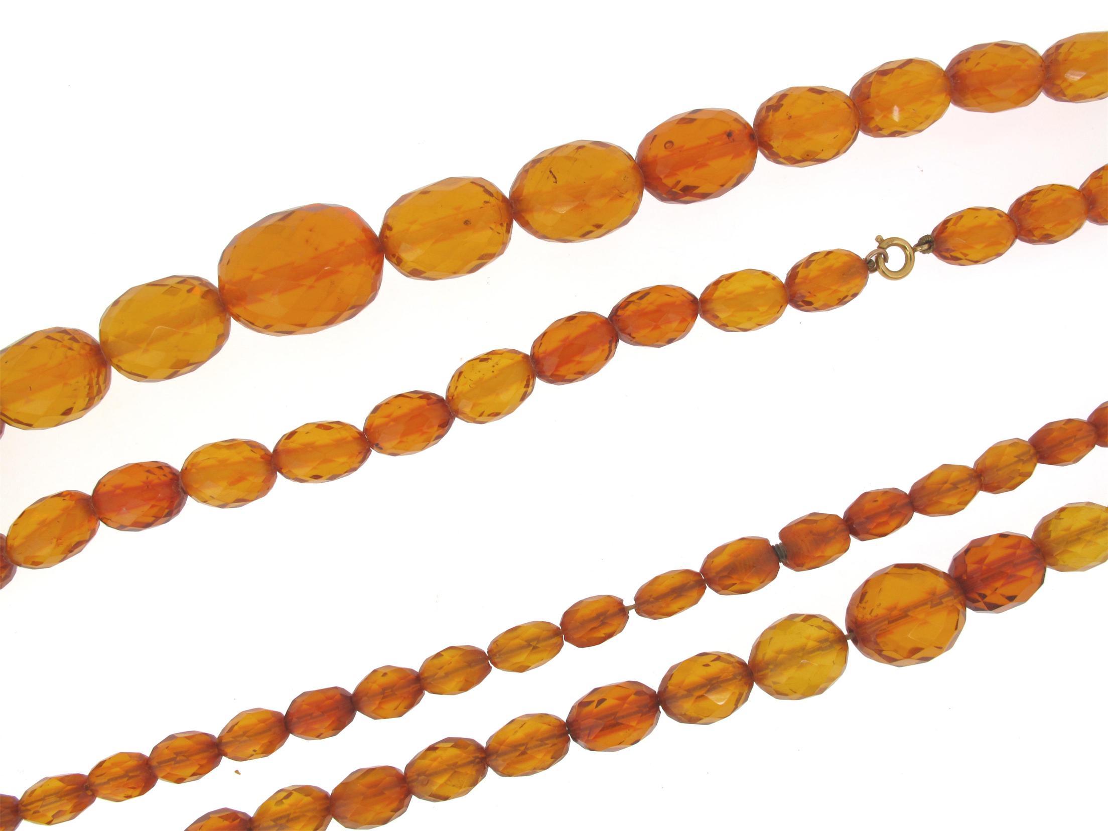 Appraisal: A graduated and faceted amber bead necklace