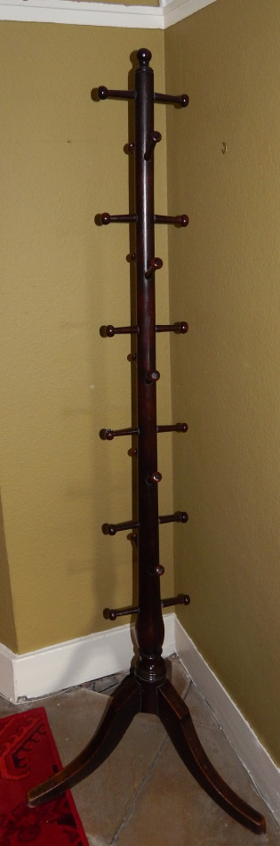 Appraisal: A turned mahogany hat and coat stand on three outsplay