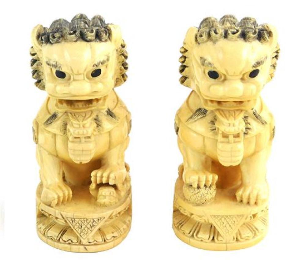 Appraisal: ASIAN Pair of carved ivory Foo Dogs deep relief carving