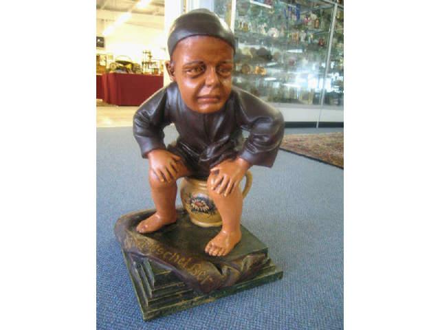 Appraisal: German Figural Advertising Piece Gnome or Dwarf seated on a