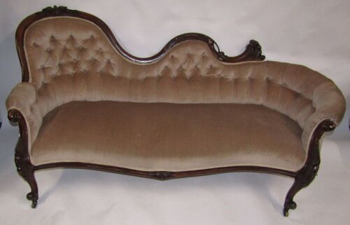 Appraisal: A Victorian walnut sofa with carved show frame having a