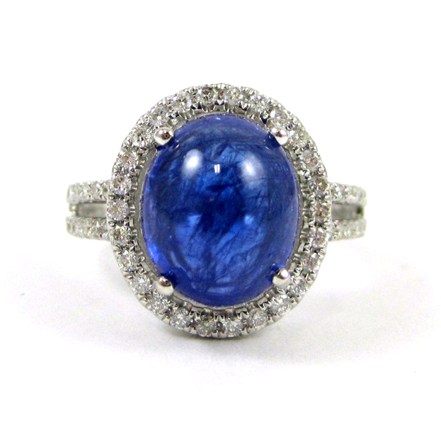 Appraisal: TANZANITE AND FOURTEEN KARAT WHITE GOLD RING with round-cut diamonds