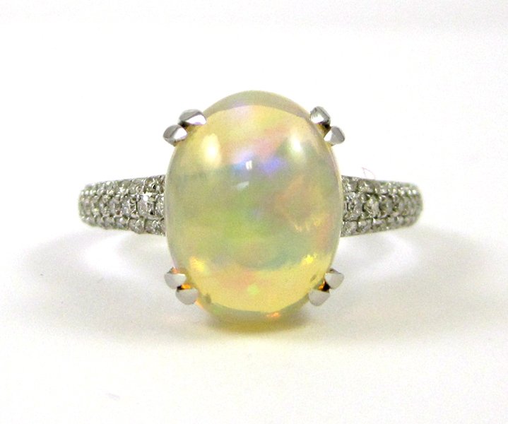 Appraisal: JELLY OPAL AND FOURTEEN KARAT WHITE GOLD RING with round-cut