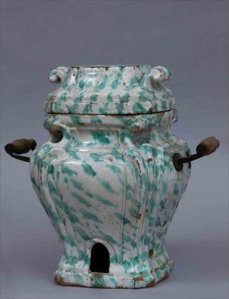 Appraisal: CONTINENTAL BAROQUE-STYLE GLAZED POTTERY TWO-HANDLED SMALL STOVE AND COVER Of