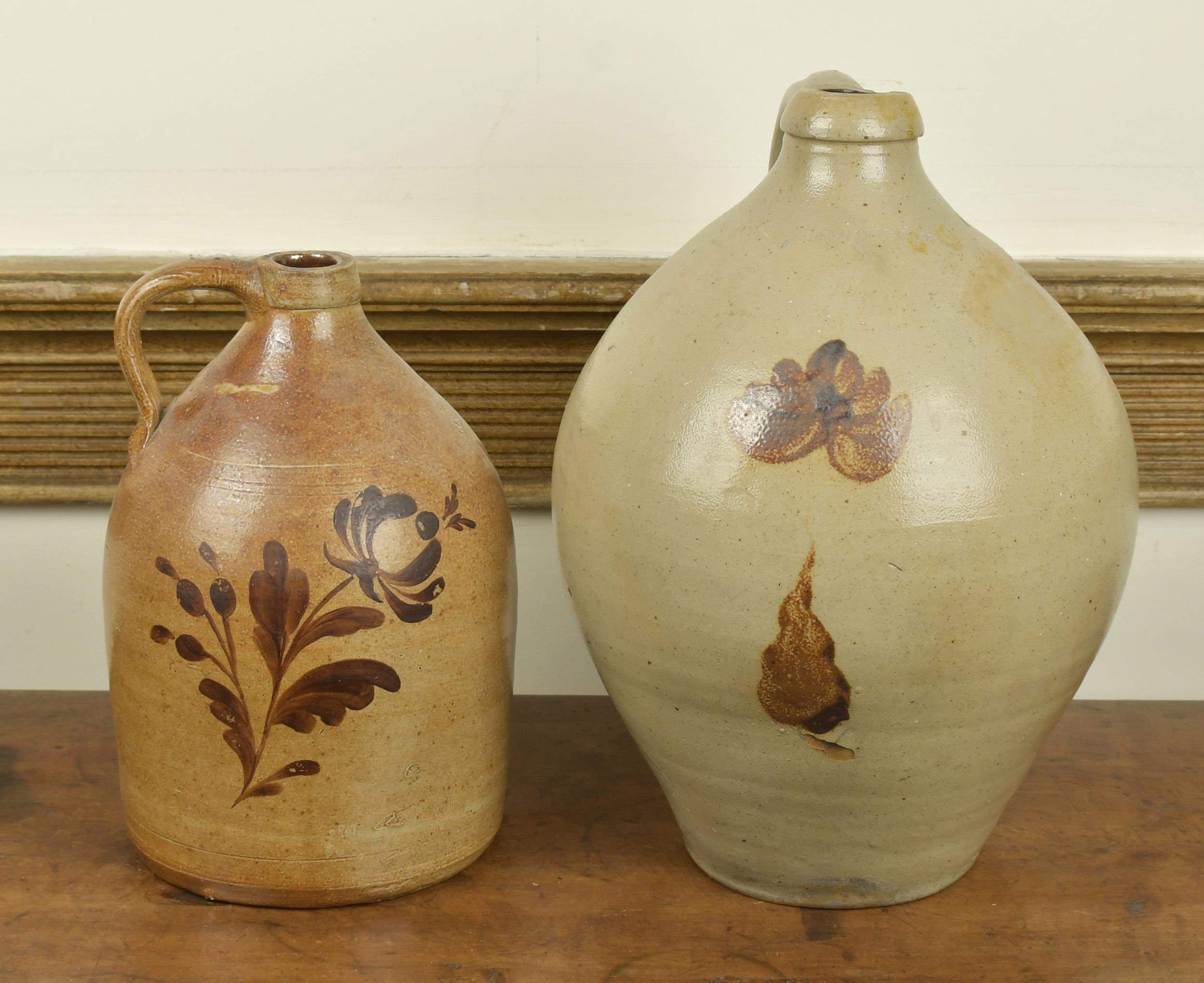 Appraisal: TWO OCHRE DECORATED STONEWARE JUGS Two gallon ovoid stone handled