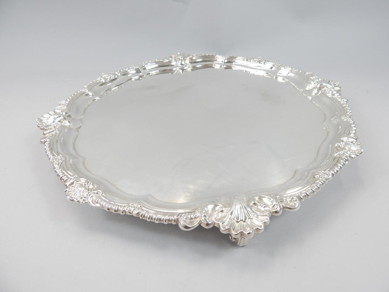 Appraisal: An Edwardian silver salver of scalloped edge outline with gadrooning