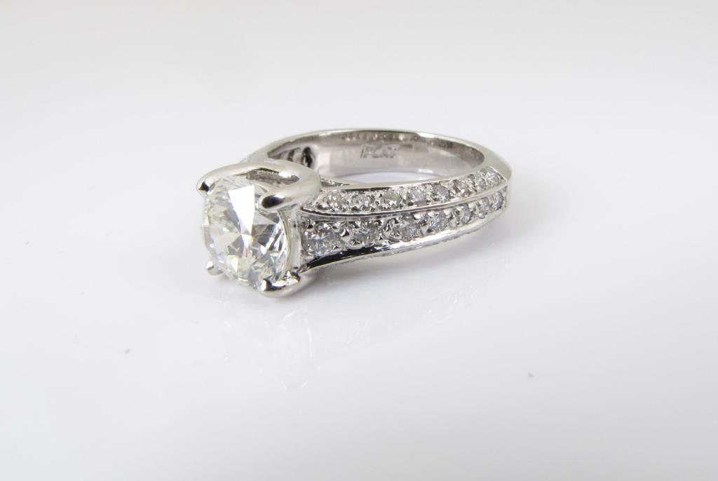 Appraisal: A platinum ring with a center ct round brilliant cut