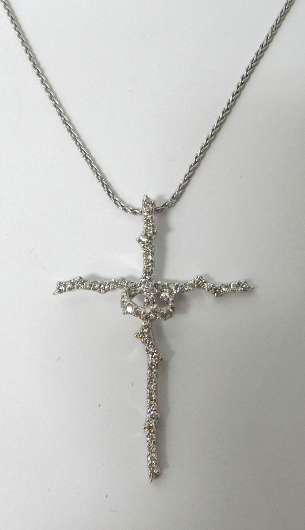 Appraisal: A diamond set pendant cross in a rustic design mounted