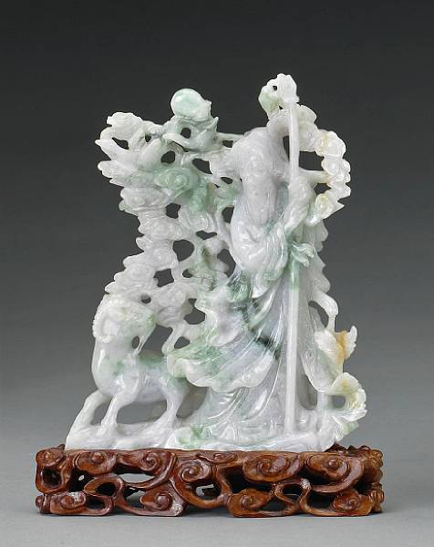 Appraisal: A mottled green and white jadeite standing figure th Century