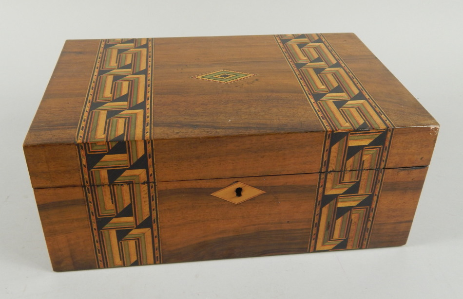 Appraisal: A Victorian walnut and parquetry workbox containing a number of