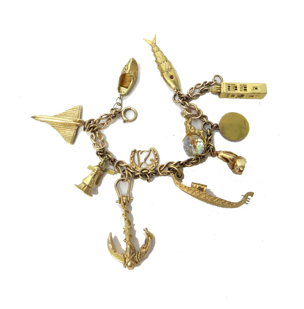 Appraisal: A ct gold charm bracelet fitted with eleven mostly ct