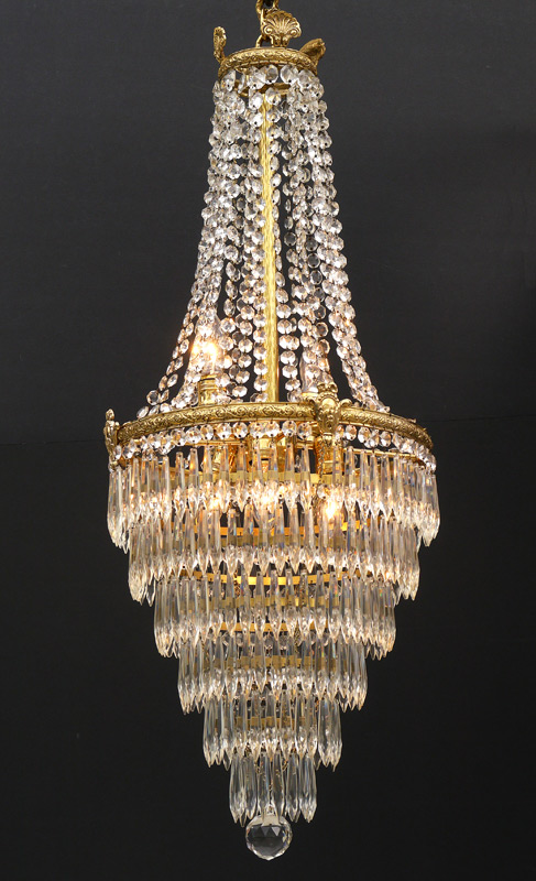 Appraisal: LIGHT BRASS CRYSTAL CHANDELIER Brass frame with garland swags over