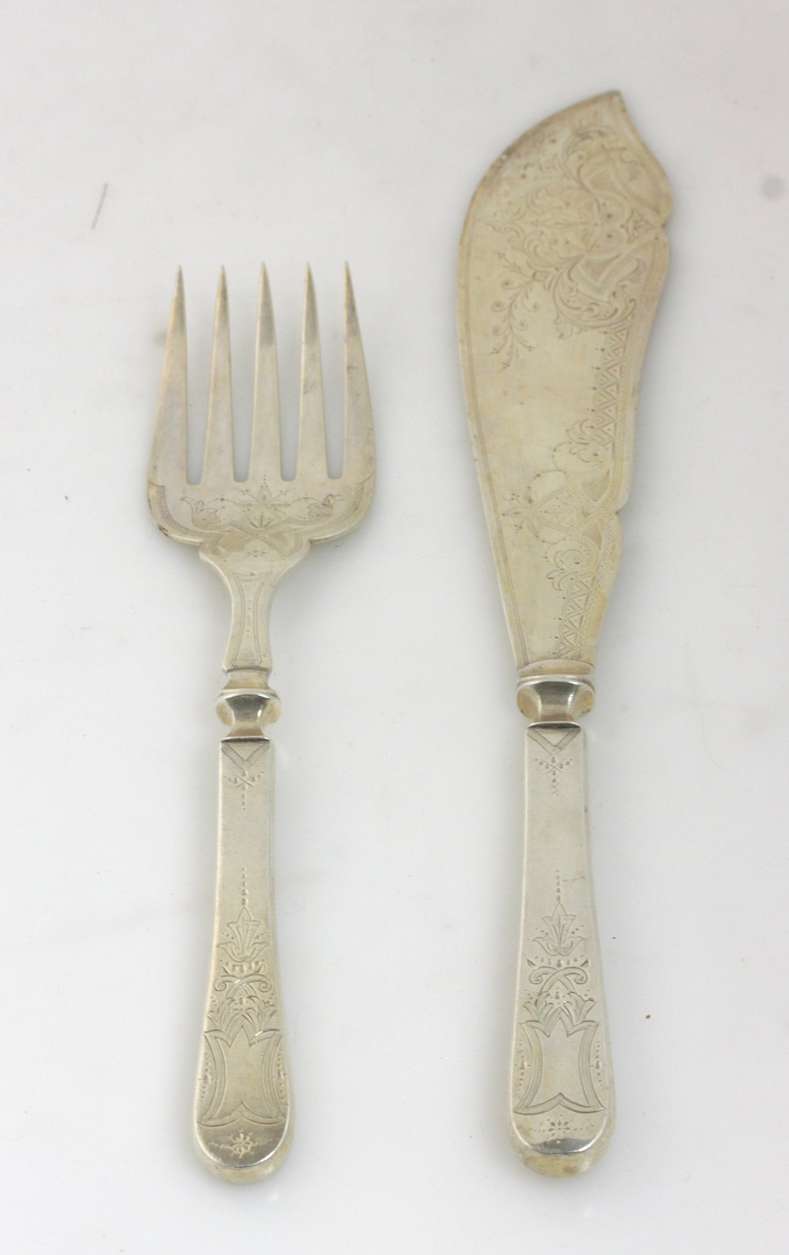 Appraisal: A pair of Victorian silver fish servers EH London with