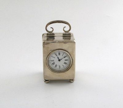 Appraisal: An Edwardian silver travelling time piece plain rectangular form hinged