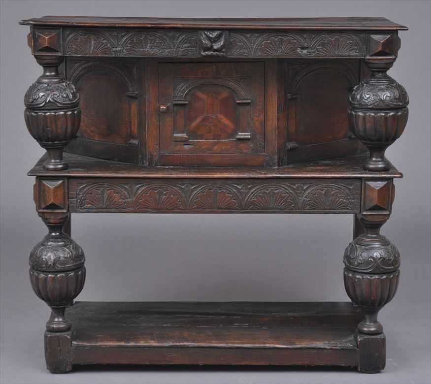 Appraisal: ELIZABETHAN CARVED OAK COURT CUPBOARD The overhanging top on reeded