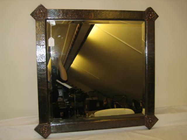 Appraisal: AN ARTS AND CRAFTS COPPER MIRROR the bevelled plate contained