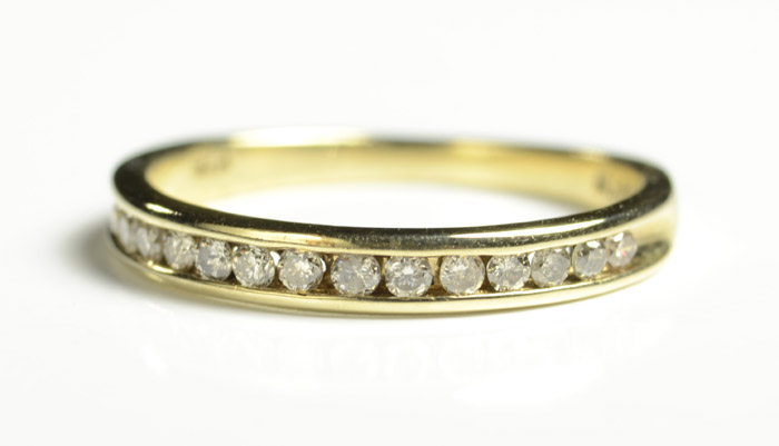 Appraisal: DIAMOND AND TEN KARAT GOLD RING with round-cut channel set