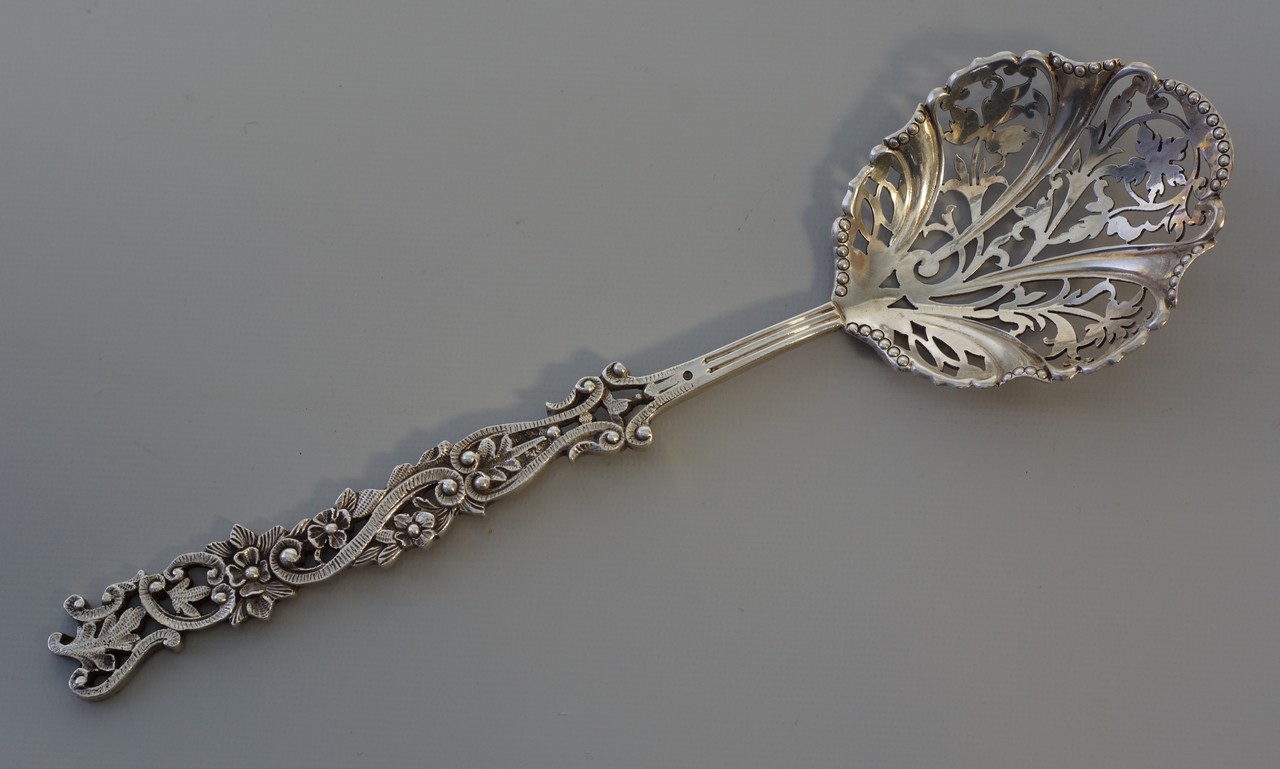 Appraisal: English Edwardian sterling silver pierced floral pattern berry serving spoon