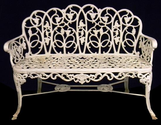 Appraisal: Iron garden bench painted white elaborately pierced with grape vine