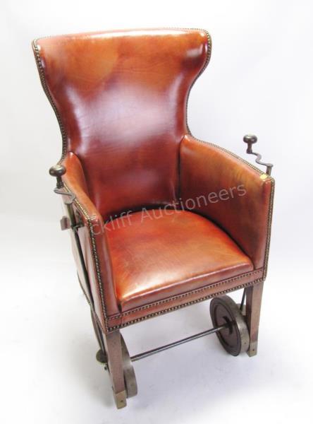 Appraisal: Antique leather convalescent chair with brass wheels hand crank driven