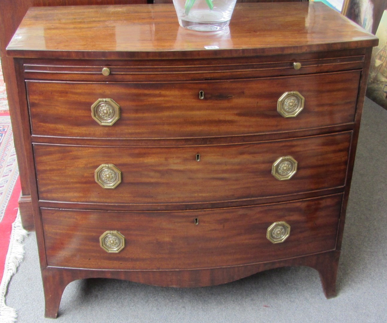 Appraisal: A Regency mahogany bowfront chest the brushing slide over three