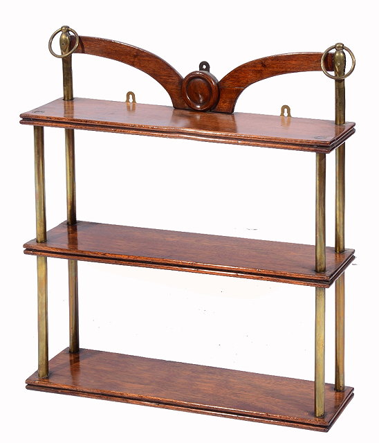 Appraisal: A THREE TIER MAHOGANY WALL SHELF with brass supports and