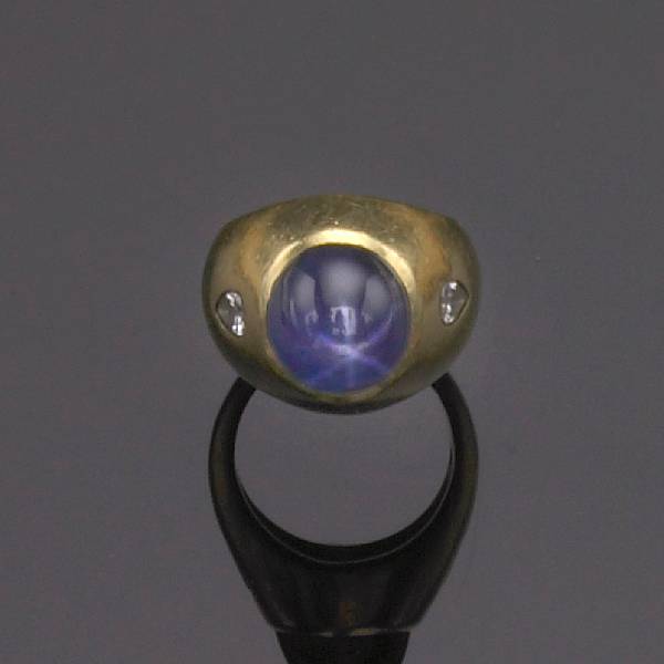 Appraisal: A cabochon sapphire diamond and gold ring with pear-shaped diamond