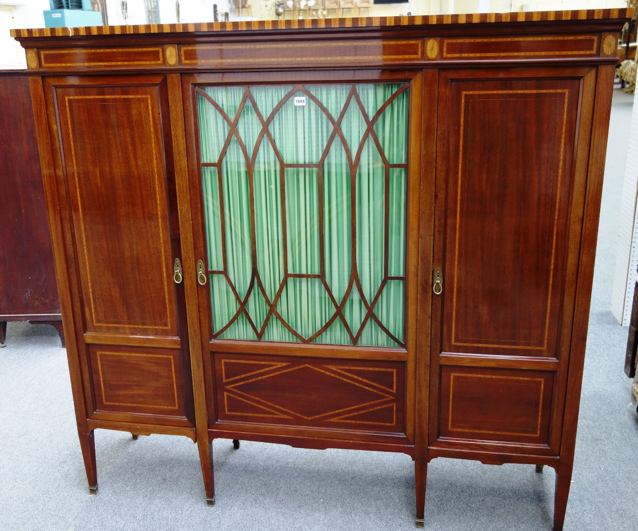 Appraisal: An Edwardian satinwood banded marquetry inlaid cupboard with central astragal