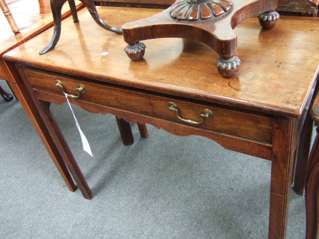 Appraisal: A George III oak side table the rectangular top over