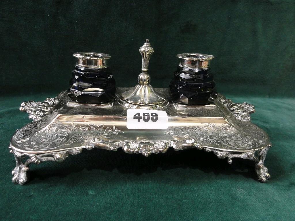 Appraisal: A silver plated ink stand with engraved scrolling decoration raised