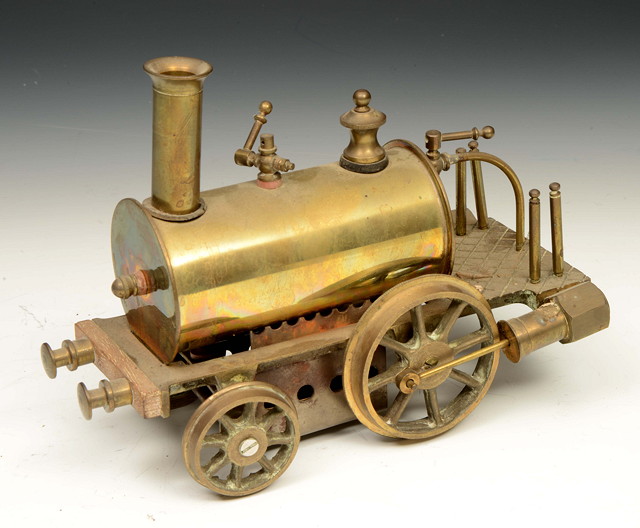 Appraisal: A SMALL BRASS SPIRIT FIRED STEAM LOCOMOTIVE with a cylindrical