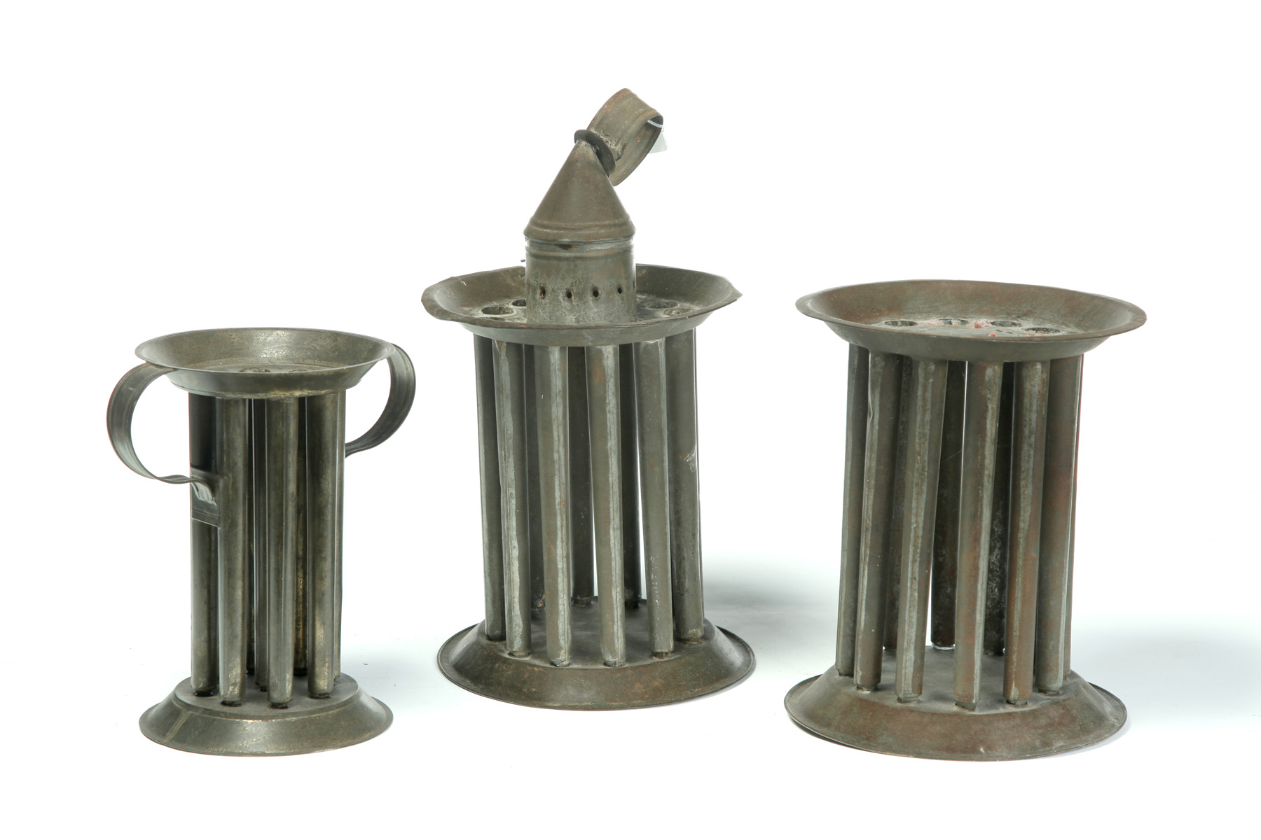 Appraisal: THREE AMERICAN CANDLE MOLDS Mid th century tin Round molds