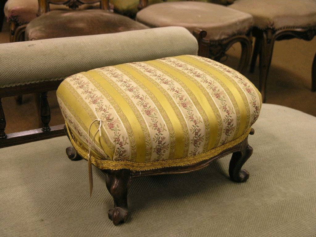 Appraisal: A Victorian walnut footstool upholstered seat four carved cabriole legs