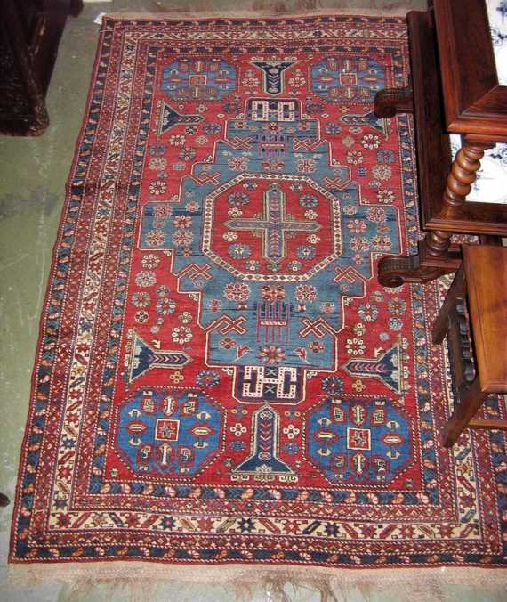 Appraisal: CAUCASIAN old Red central field with a blue central medallion