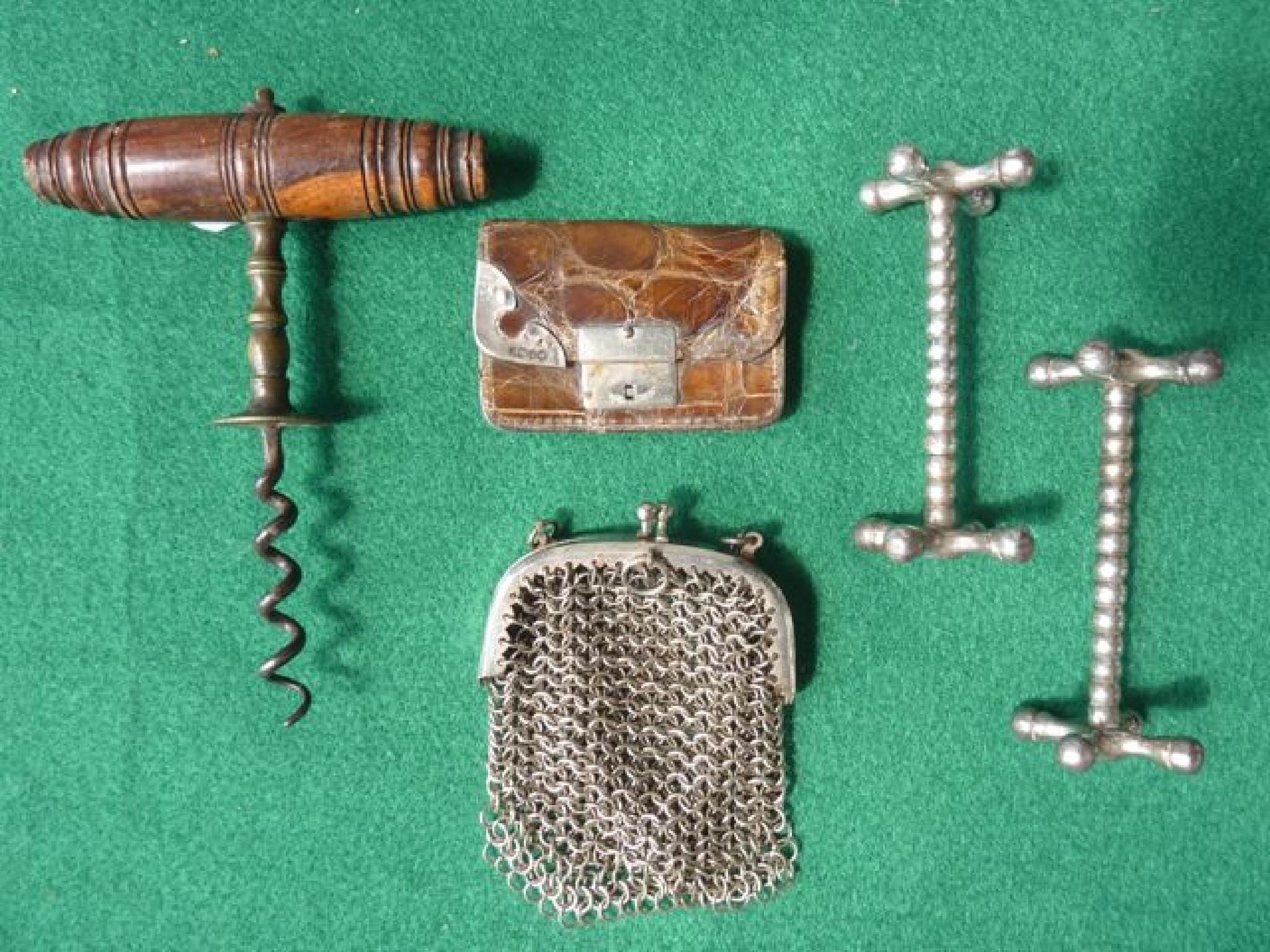 Appraisal: A small crocodile and silver mounted purse corkscrew knife rests