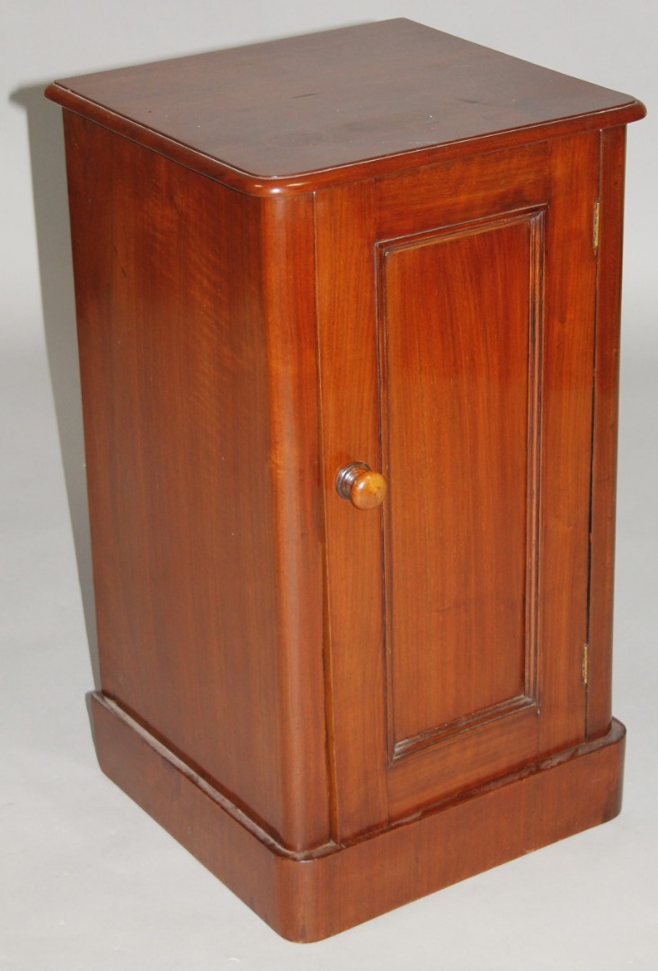 Appraisal: A Victorian mahogany pot cupboard the D-end top raised above