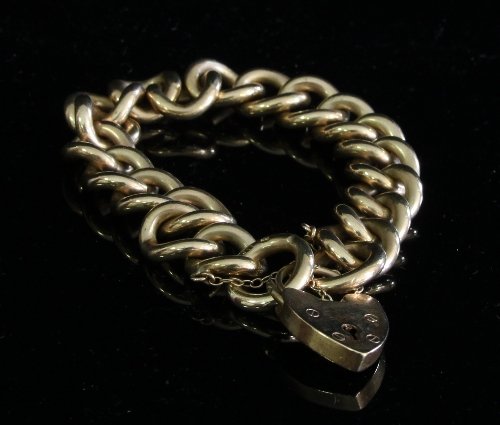 Appraisal: A ct gold curb-link bracelet with heart shaped padlock clasp