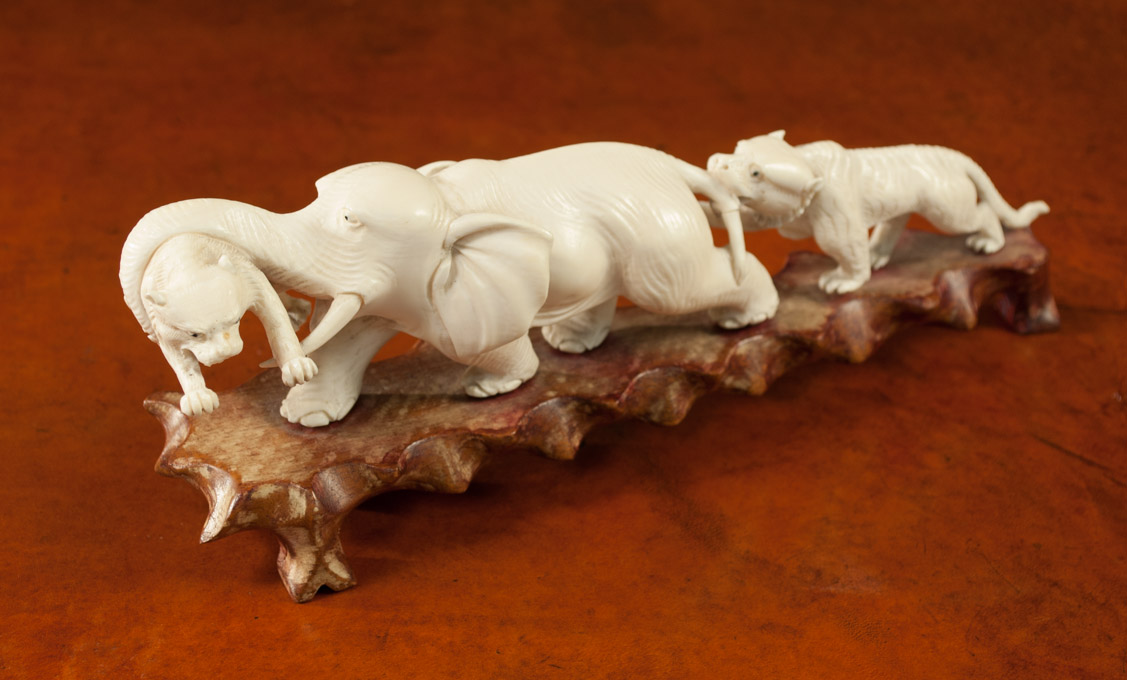 Appraisal: CHINESE CARVED IVORY ELEPHANT AND TIGER SCULPTURE featuring two tigers