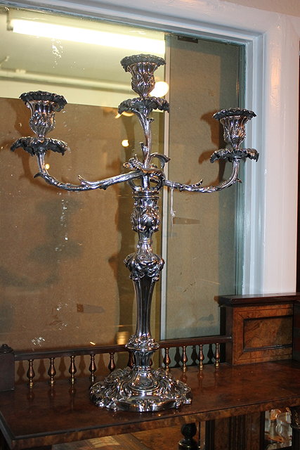 Appraisal: A VICTORIAN SILVER PLATED THREE BRANCH CANDELABRA with scroll base