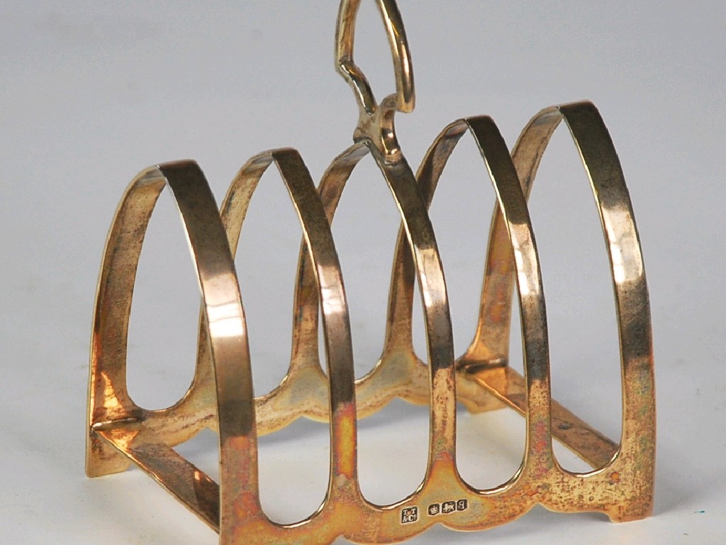 Appraisal: GEORGE V SILVER FOUR DIVISIONS TOAST RACK with arched divisions