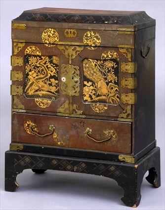 Appraisal: JAPANESE BRASS-MOUNTED LACQUER TABLE CABINET ON STAND The hinged top