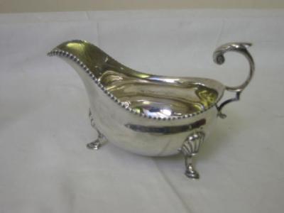 Appraisal: A SAUCE BOAT of Georgian design with gadrooned rim leaf