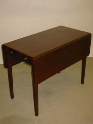 Appraisal: A MAHOGANY PEMBROKE TABLE the rounded oblong top with ebony