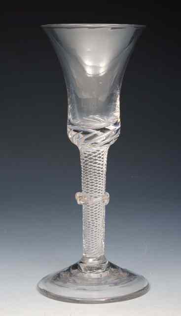 Appraisal: A MULTIPLE SPIRAL AIRTWIST STEM WINE GLASS with vermicular collar