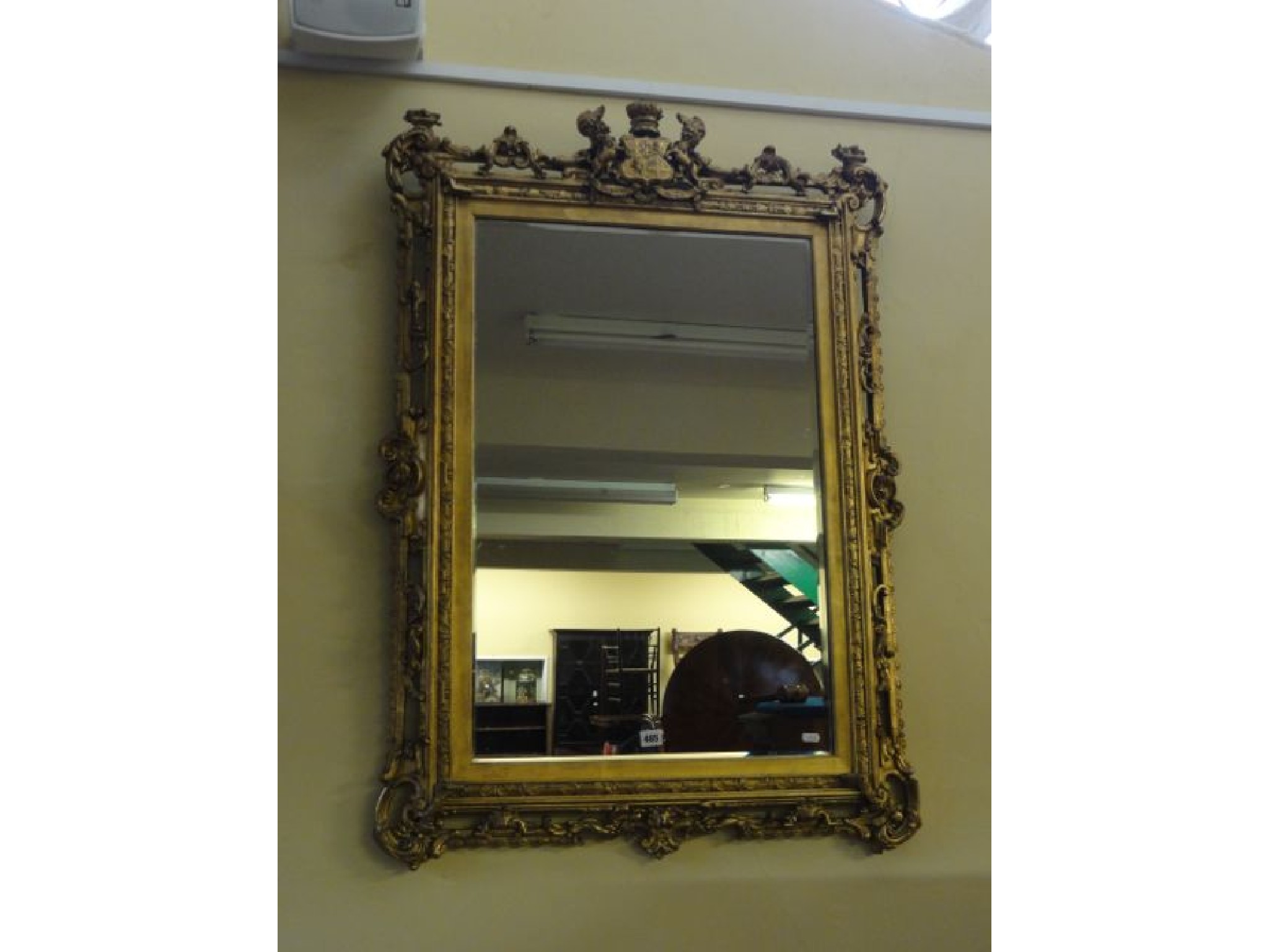 Appraisal: A mid th century gilt framed mirror bearing the coat