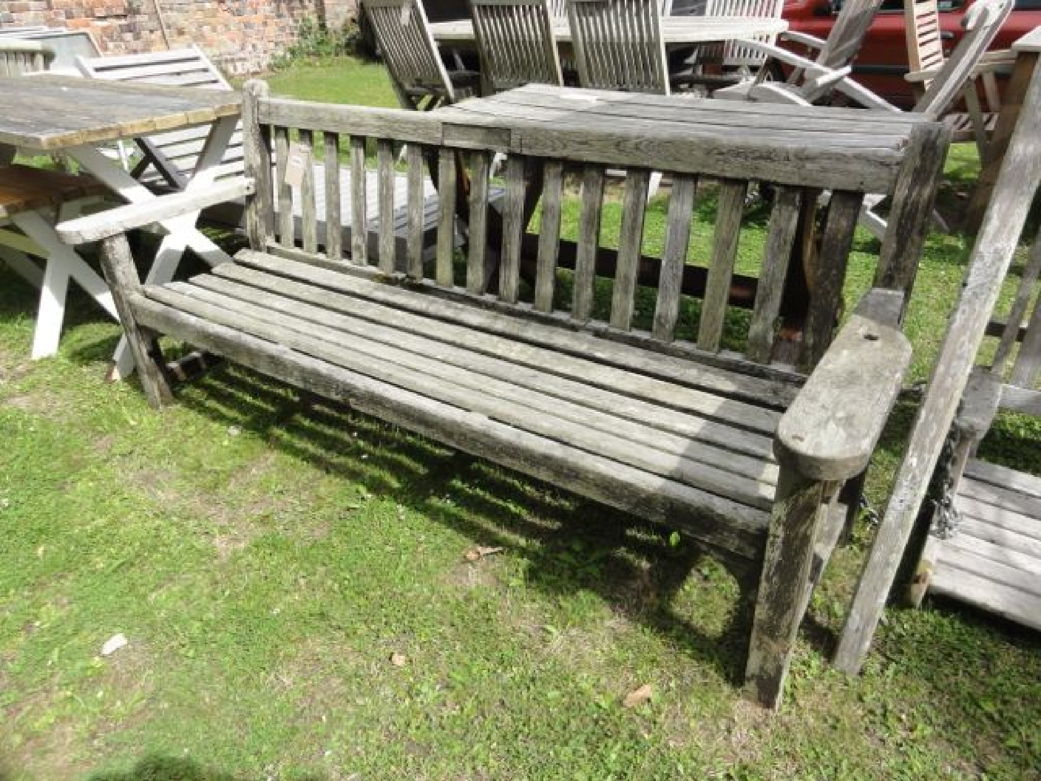 Appraisal: A weathered Lister teak three seat garden bench with slatted