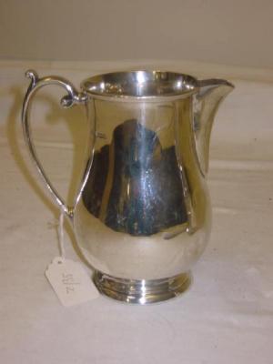 Appraisal: A JUG of baluster form with moulded rim scroll loop