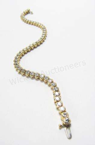 Appraisal: An K yellow gold tennis bracelet with ctw bezel set