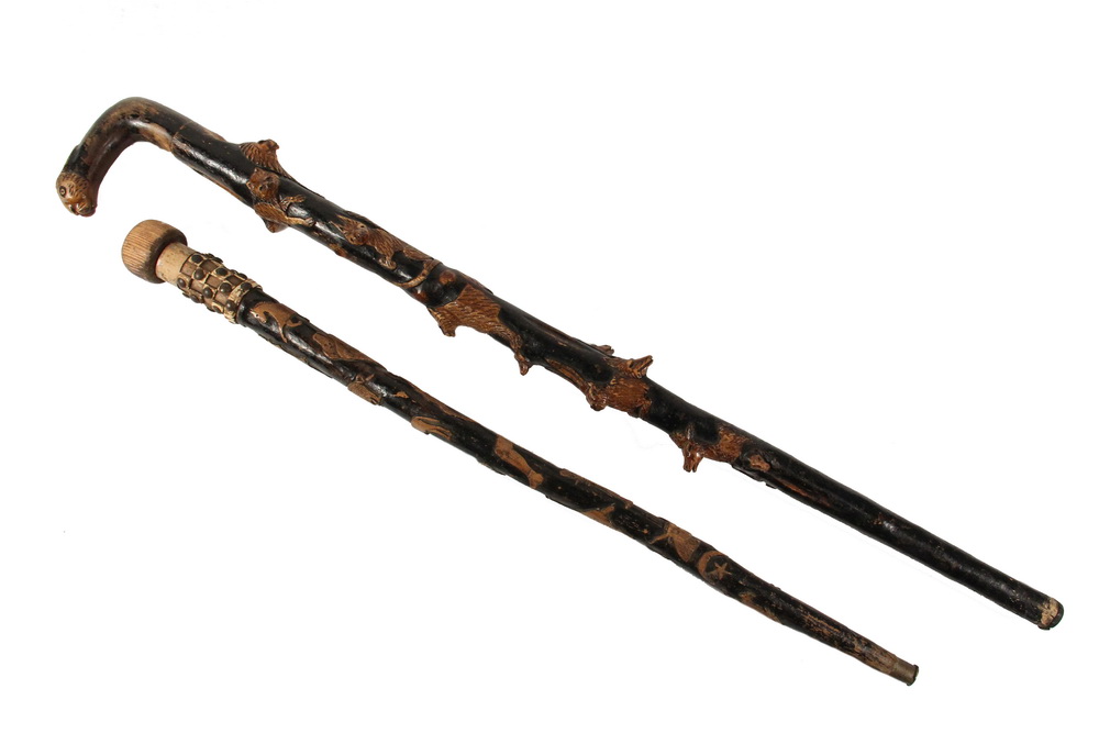 Appraisal: FOLK ART CANES - Both th c with relief animal