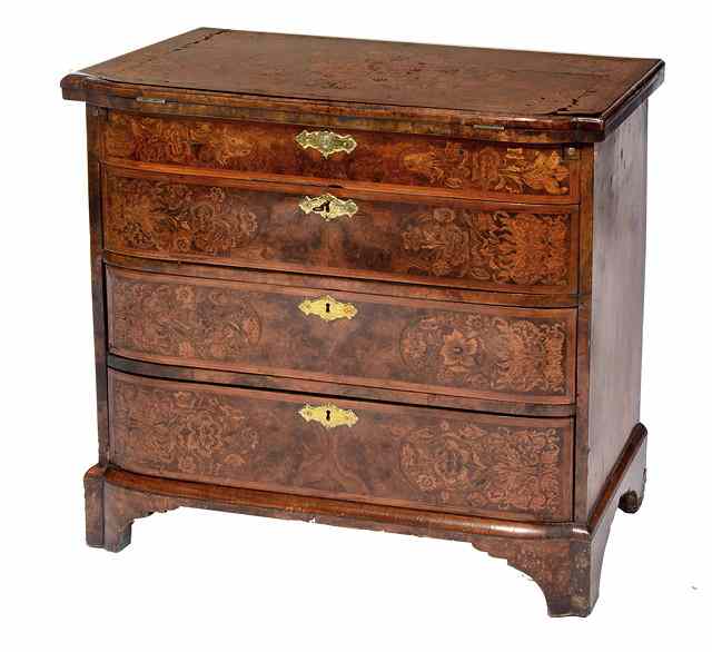 Appraisal: AN ANTIQUE WALNUT AND MARQUETRY BACHELOR'S CHEST of slightly bowed